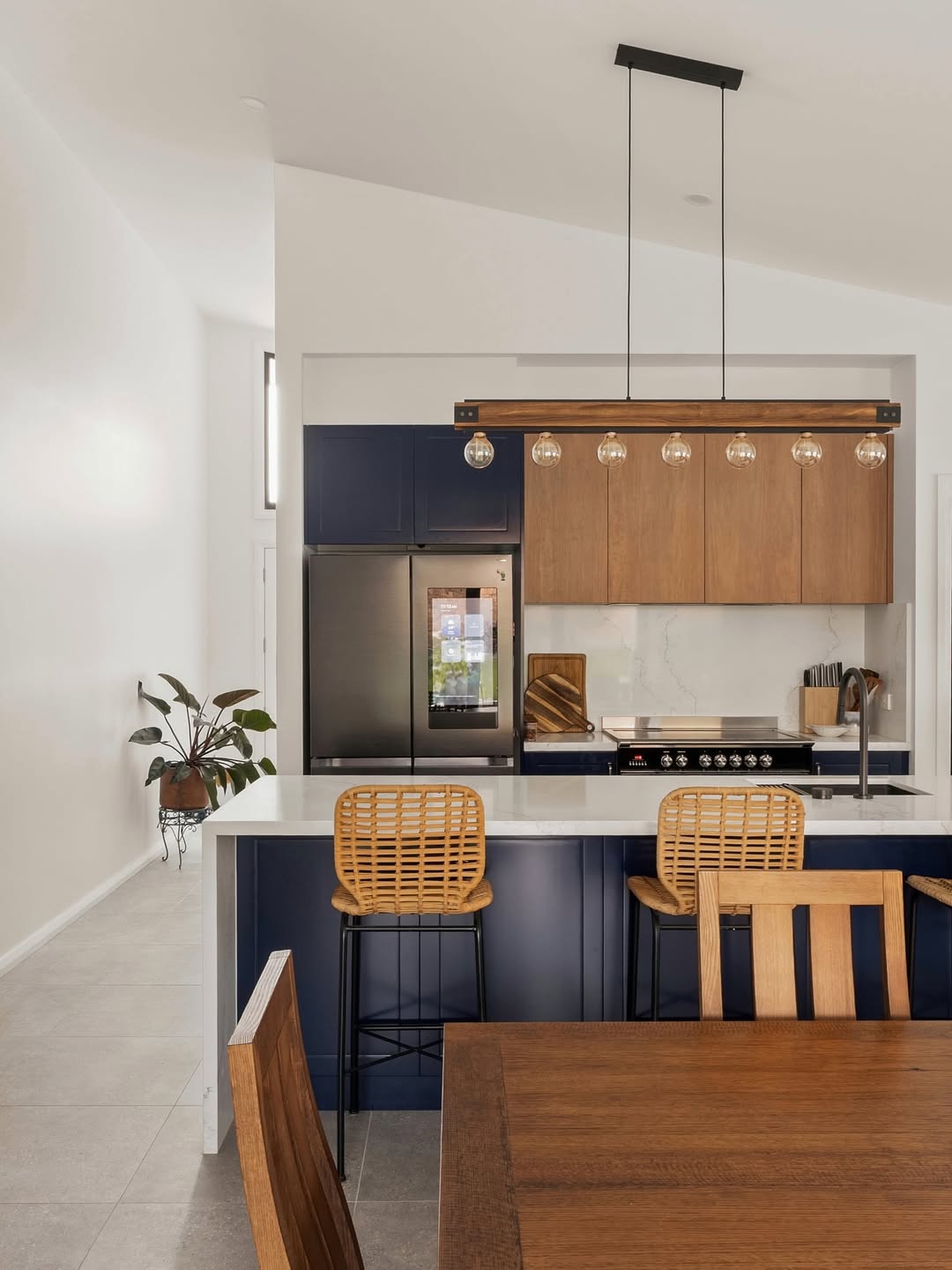 Completed kitchen renovation with navy shaker cabinetry and timber accents